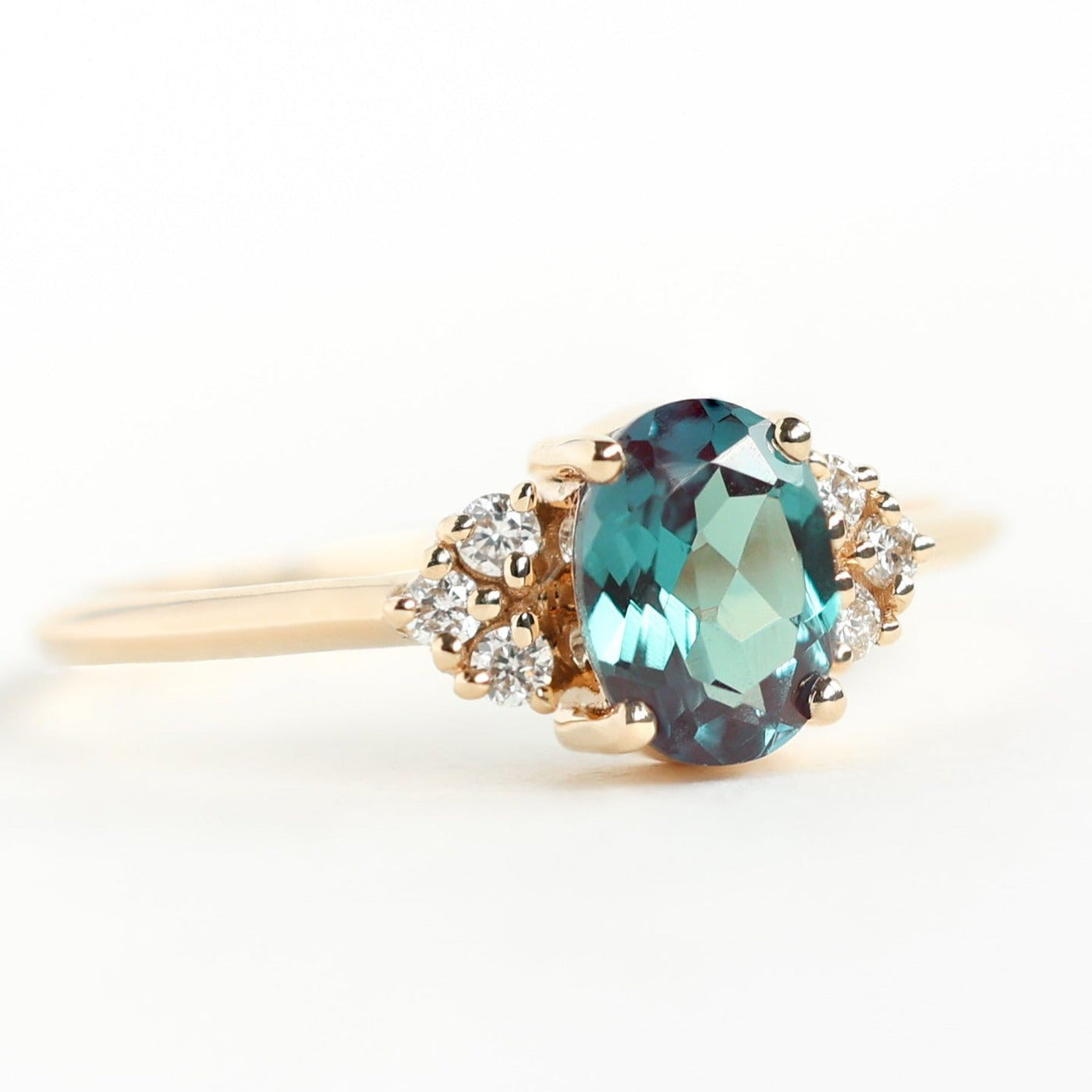 Teal Oval Alexandrite Ring Set with Nesting Band holding White Diamonds