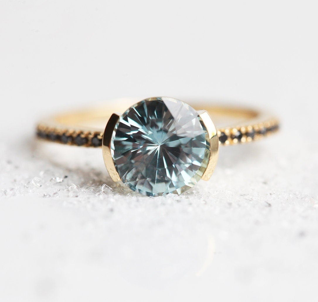 Round blue sapphire ring with black side diamond