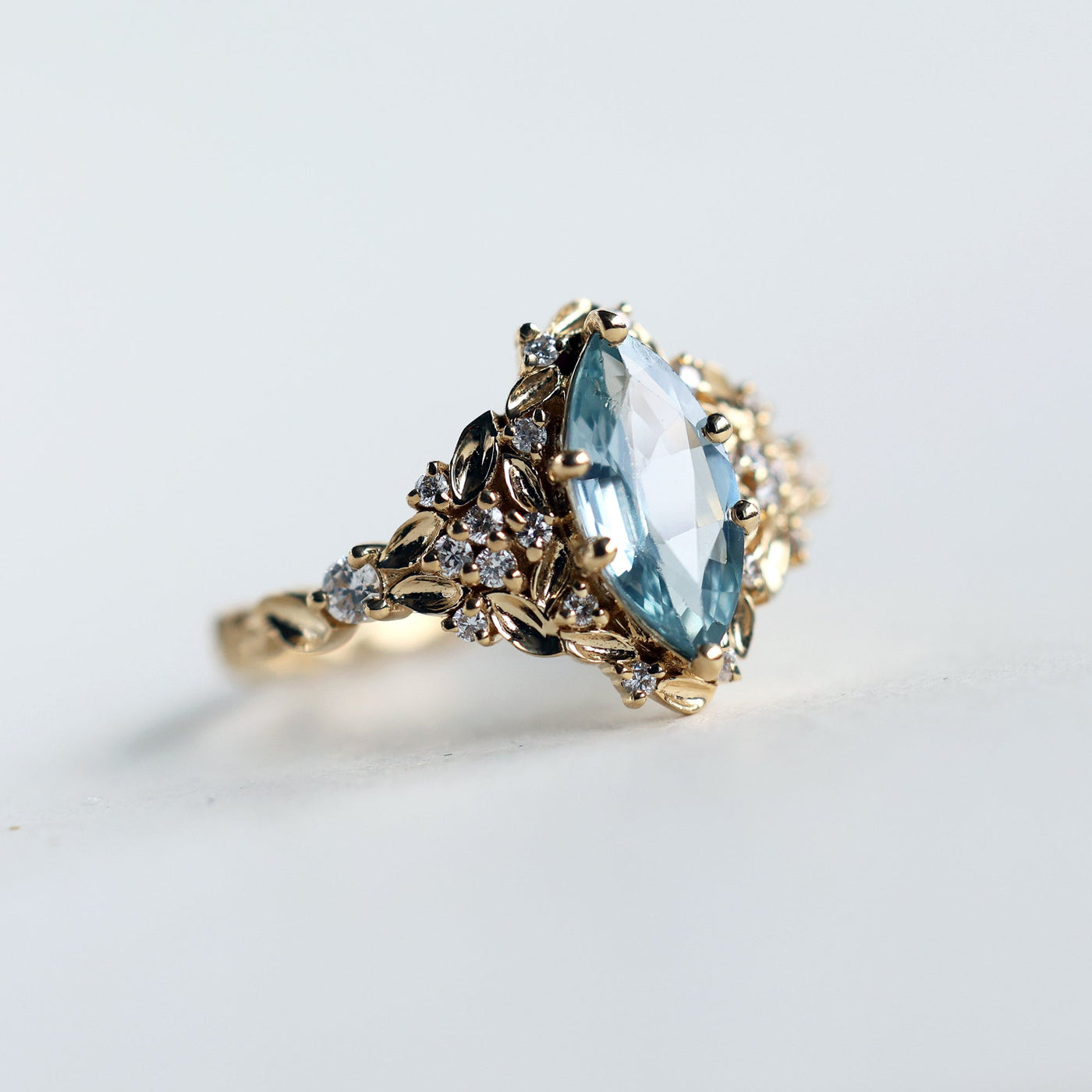 Elara marquise aqua sapphire ring with leaf detail and diamonds