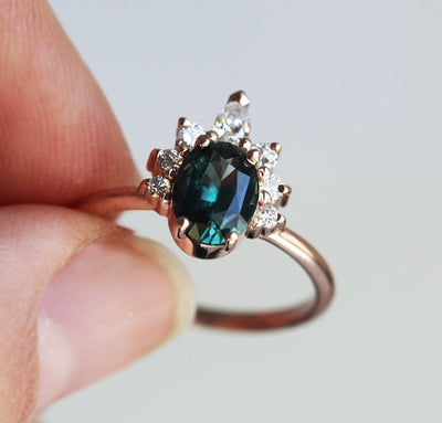 Oval teal sapphire ring with diamond halo