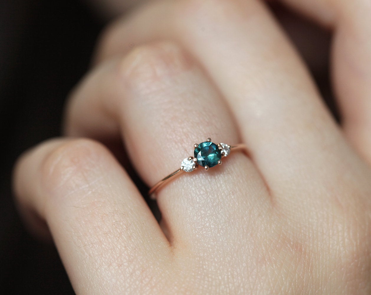 Round teal sapphire ring with diamonds