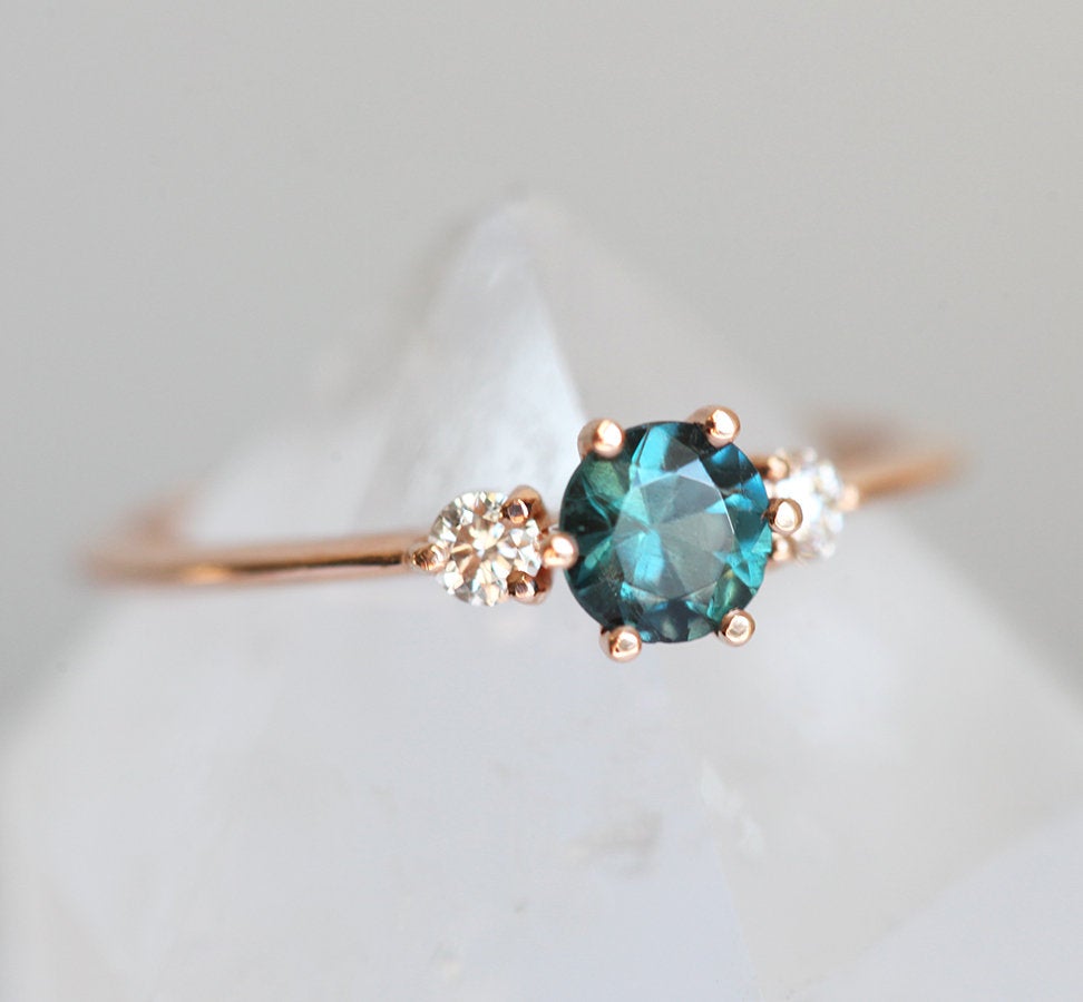 Round teal sapphire ring with diamonds