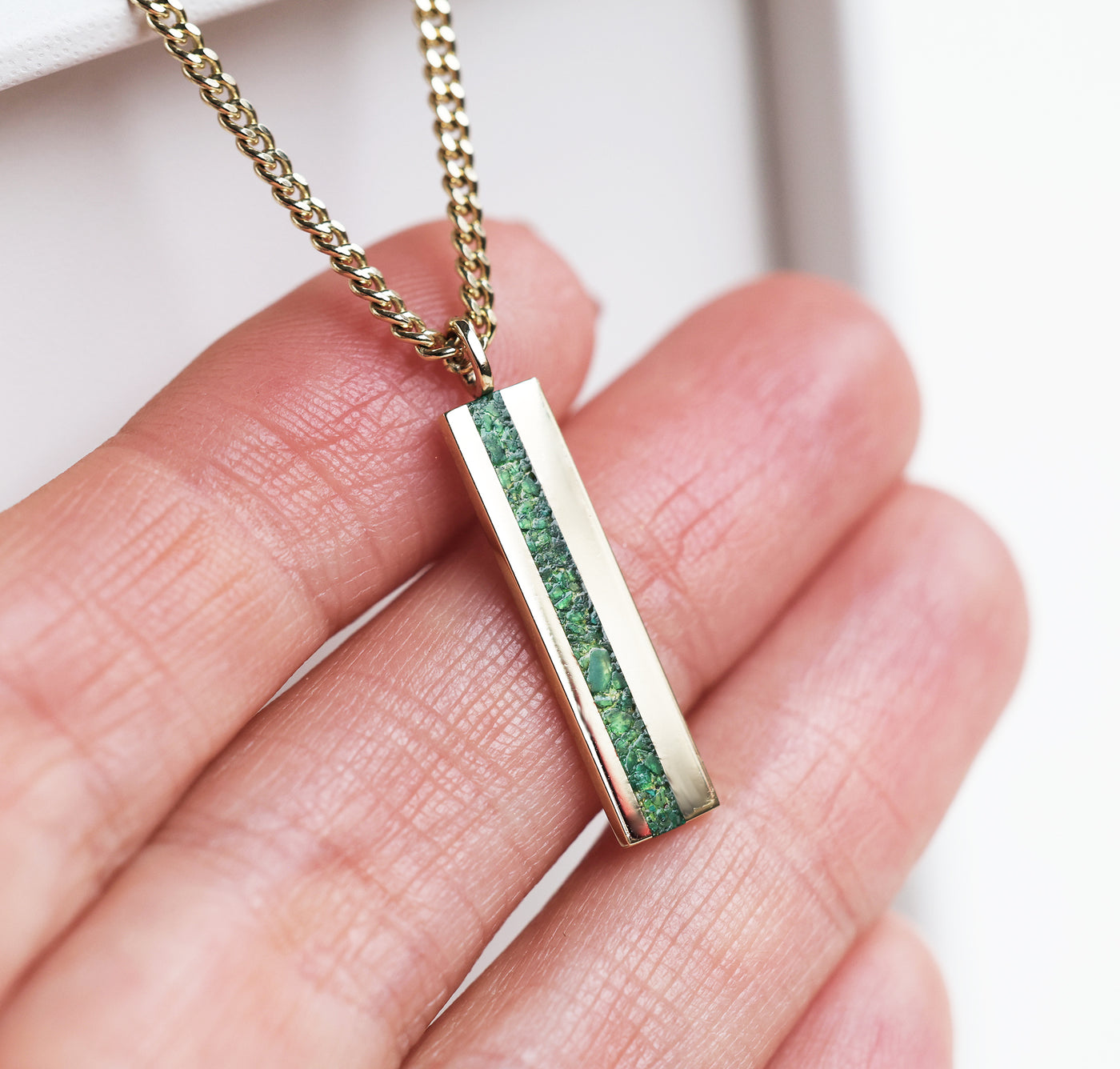 Men's emerald bar gold chain necklace in hand