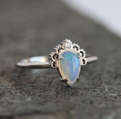 White Oval Opal Ring Crowned with a Round White Diamond