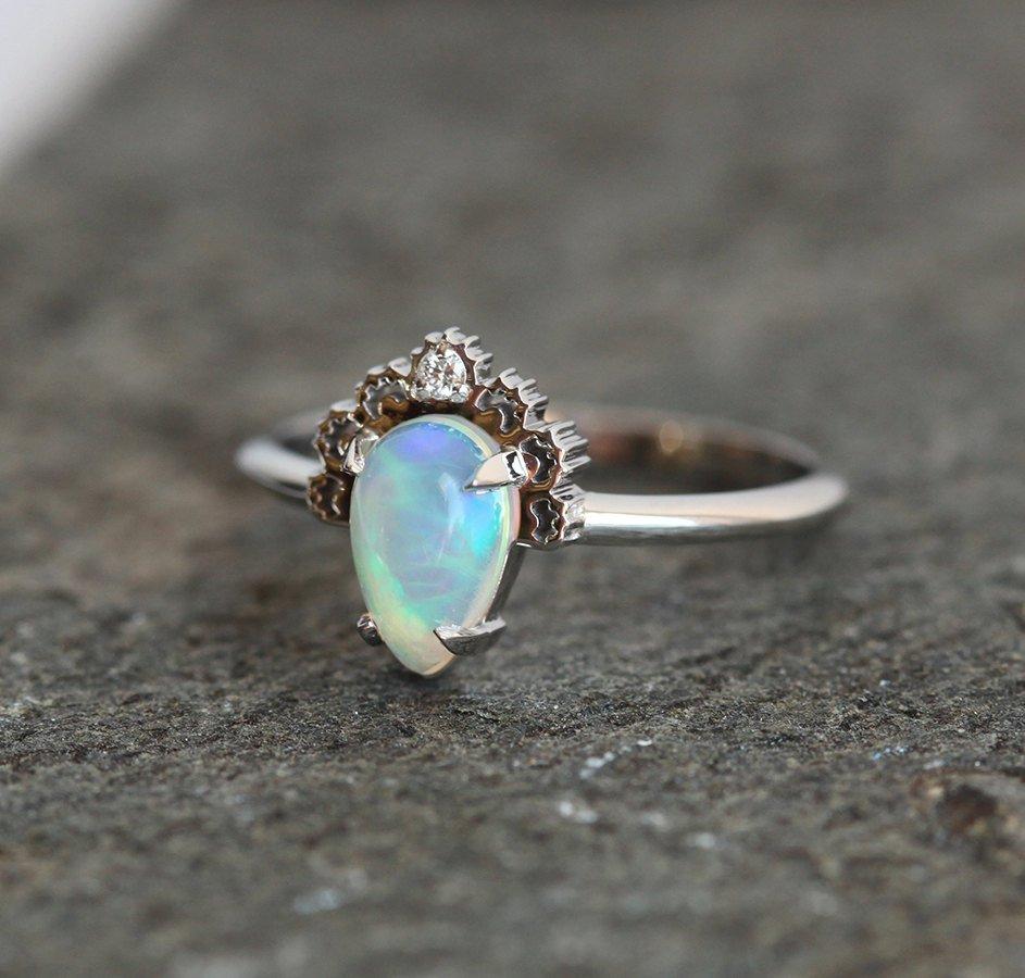 White Oval Opal Ring Crowned with a Round White Diamond