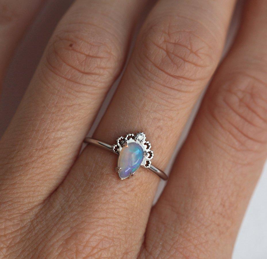White Oval Opal Ring Crowned with a Round White Diamond
