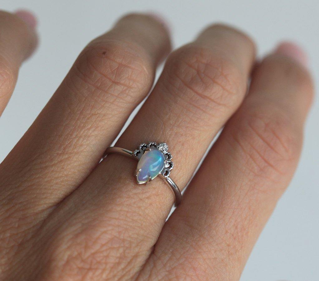 White Oval Opal Ring Crowned with a Round White Diamond