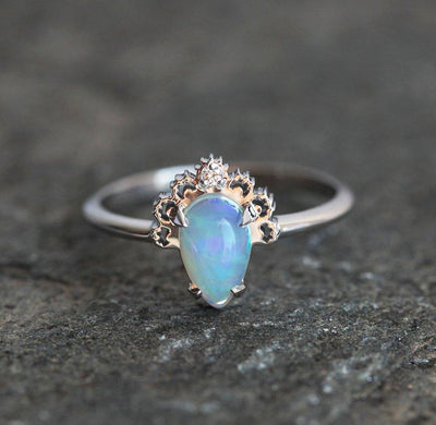 White Oval Opal Ring Crowned with a Round White Diamond