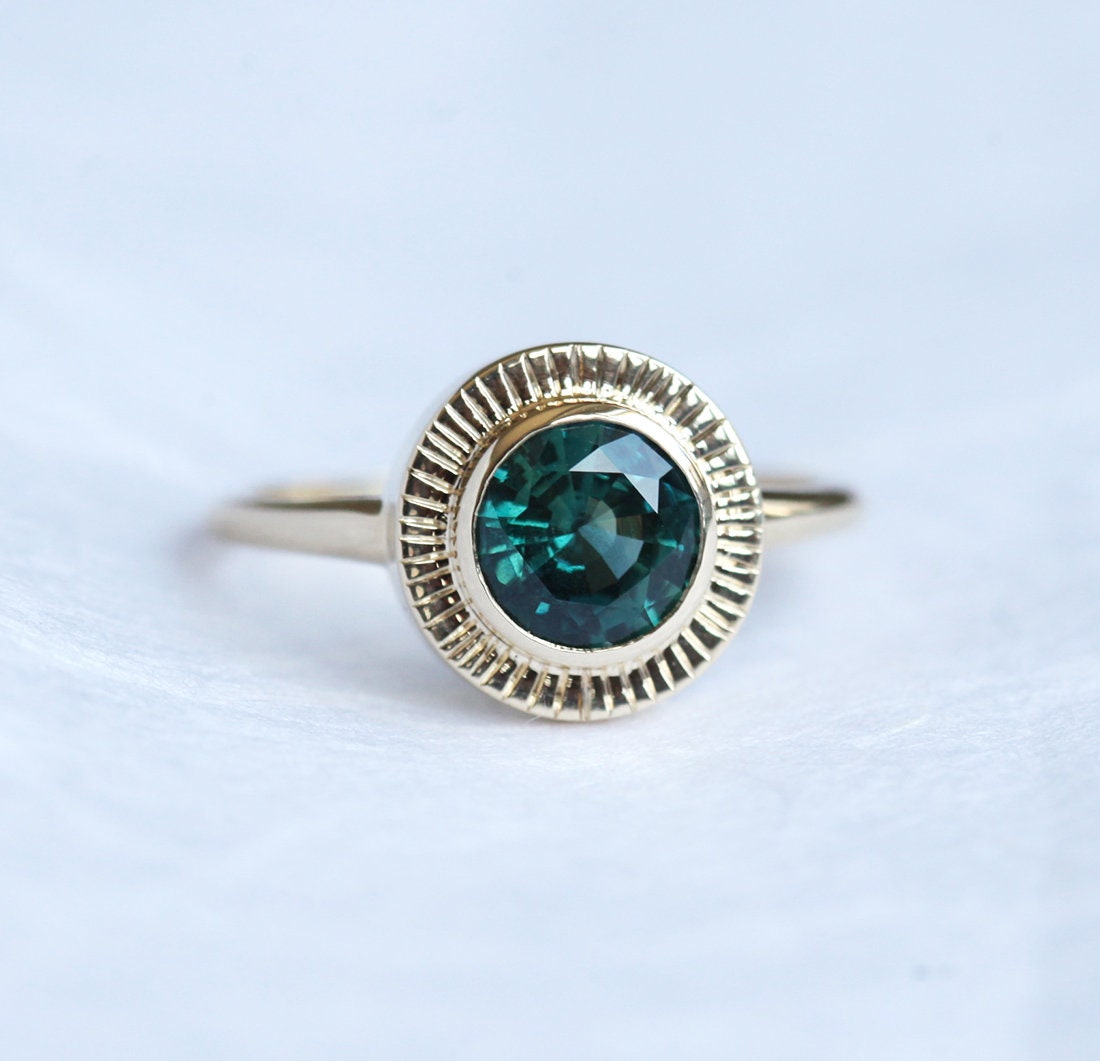 Round teal sapphire ring