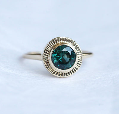 Round teal sapphire ring