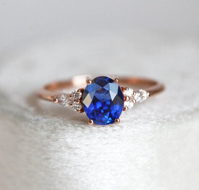 Oval sapphire cluster ring with white side diamonds