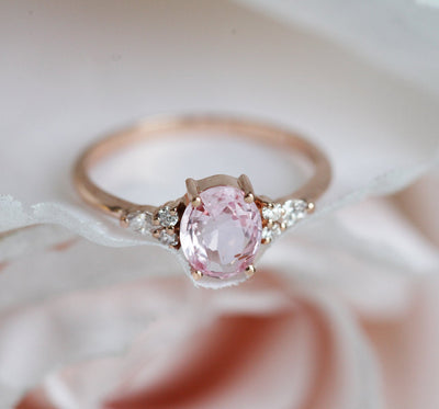 Oval peach pink sapphire with white side diamonds