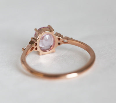 Oval peach pink sapphire with white side diamonds