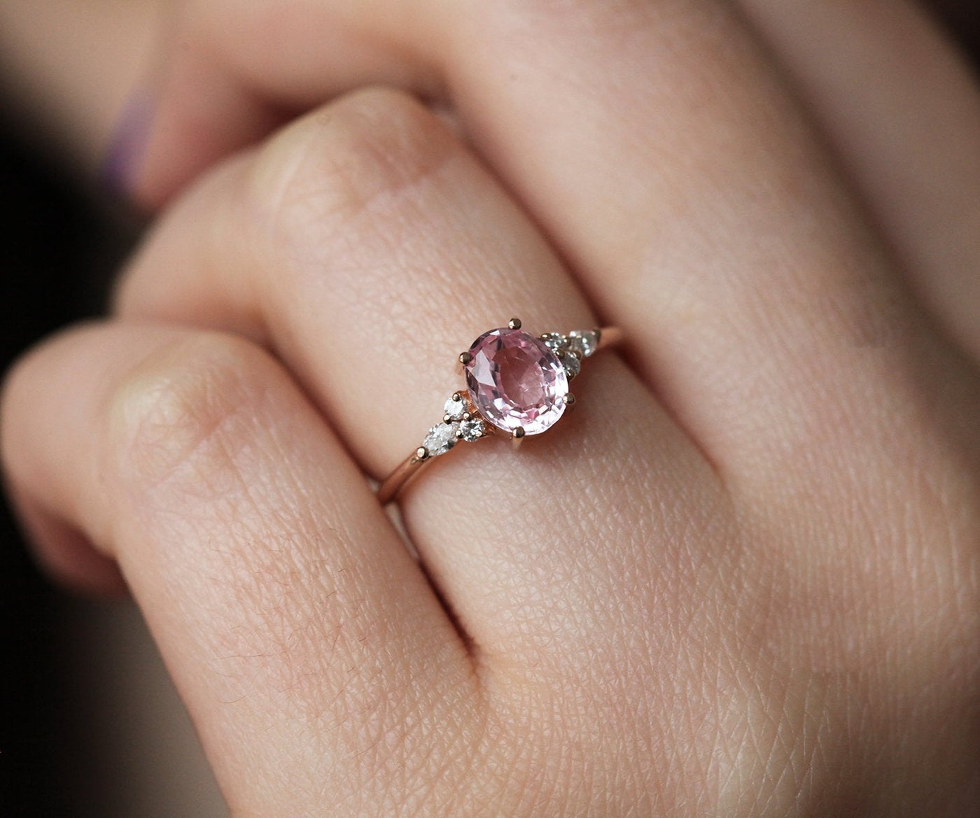 Oval peach pink sapphire with white side diamonds