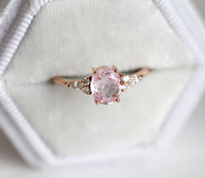 Oval peach pink sapphire with white side diamonds