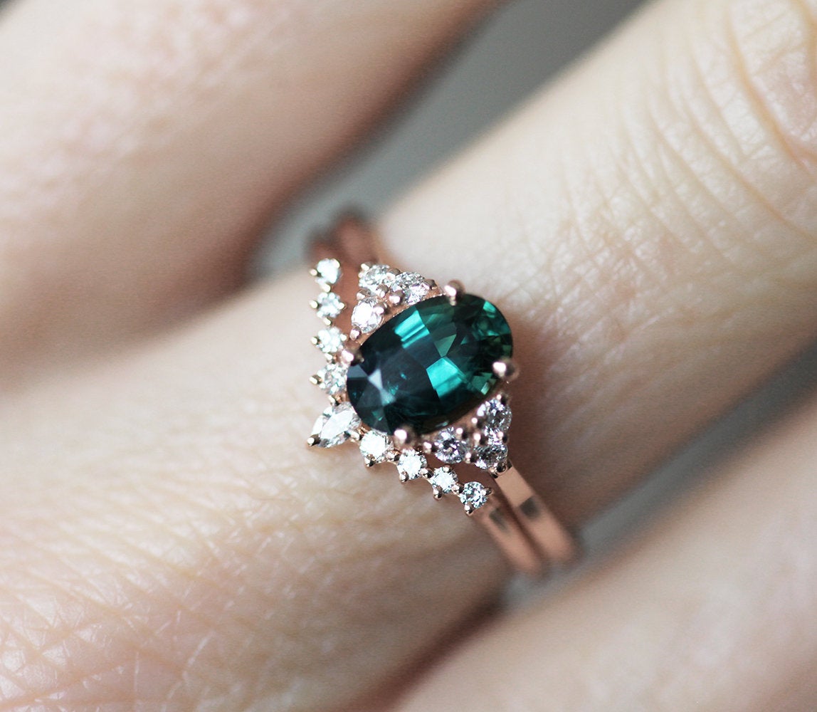 Oval teal sapphire cluster ring with diamonds