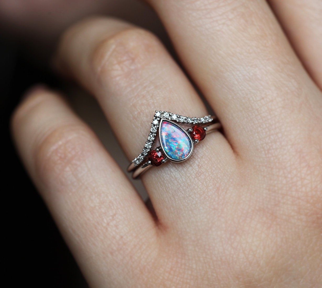 Three-Stone Black Pear Australian Opal Ring with Accent Red Round Garnet Gemstones with Diamond Crown Band