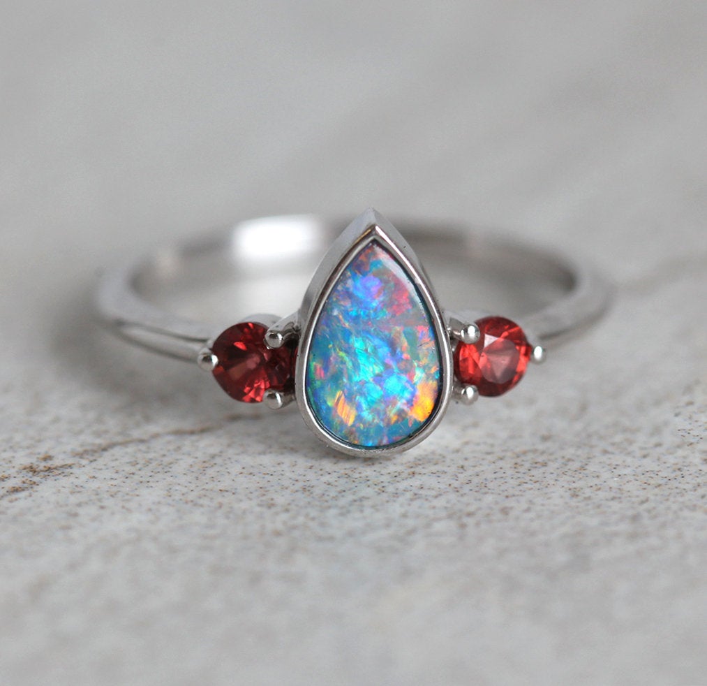 Three-Stone Black Pear Australian Opal Ring with Accent Red Round Garnet Gemstones
