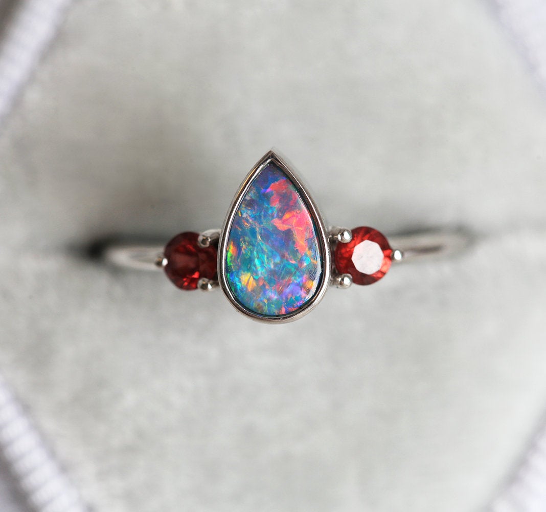 Three-Stone Black Pear Australian Opal Ring with Accent Red Round Garnet Gemstones