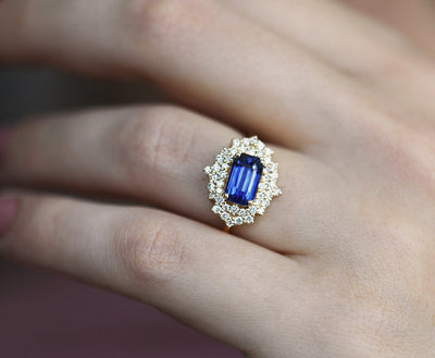 Radiant blue sapphire ring with diamond halo