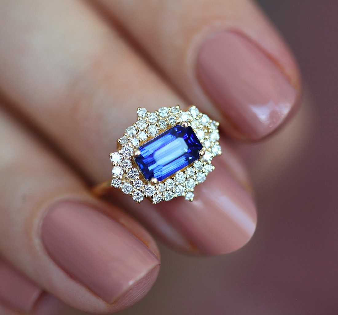 Radiant blue sapphire ring with diamond halo