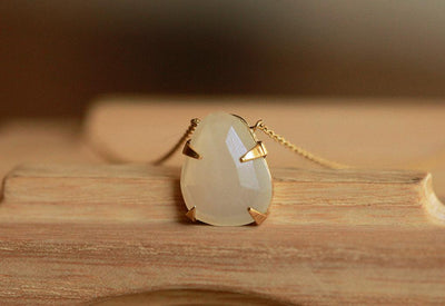 Gold necklace with white opal pendant