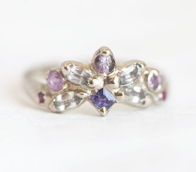 Square-shaped purple sapphire ring with sapphire and ruby side stones
