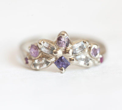 Square-shaped purple sapphire ring with sapphire and ruby side stones