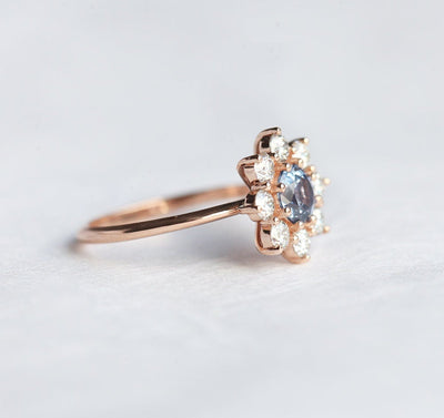Round light blue sapphire ring with diamond halo