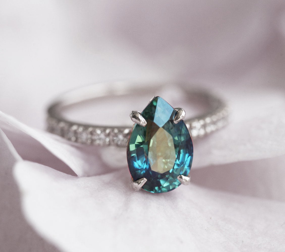 Pear-shaped blue sapphire ring with white side diamonds