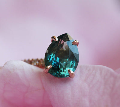 Pear-shaped blue sapphire ring with white side diamonds