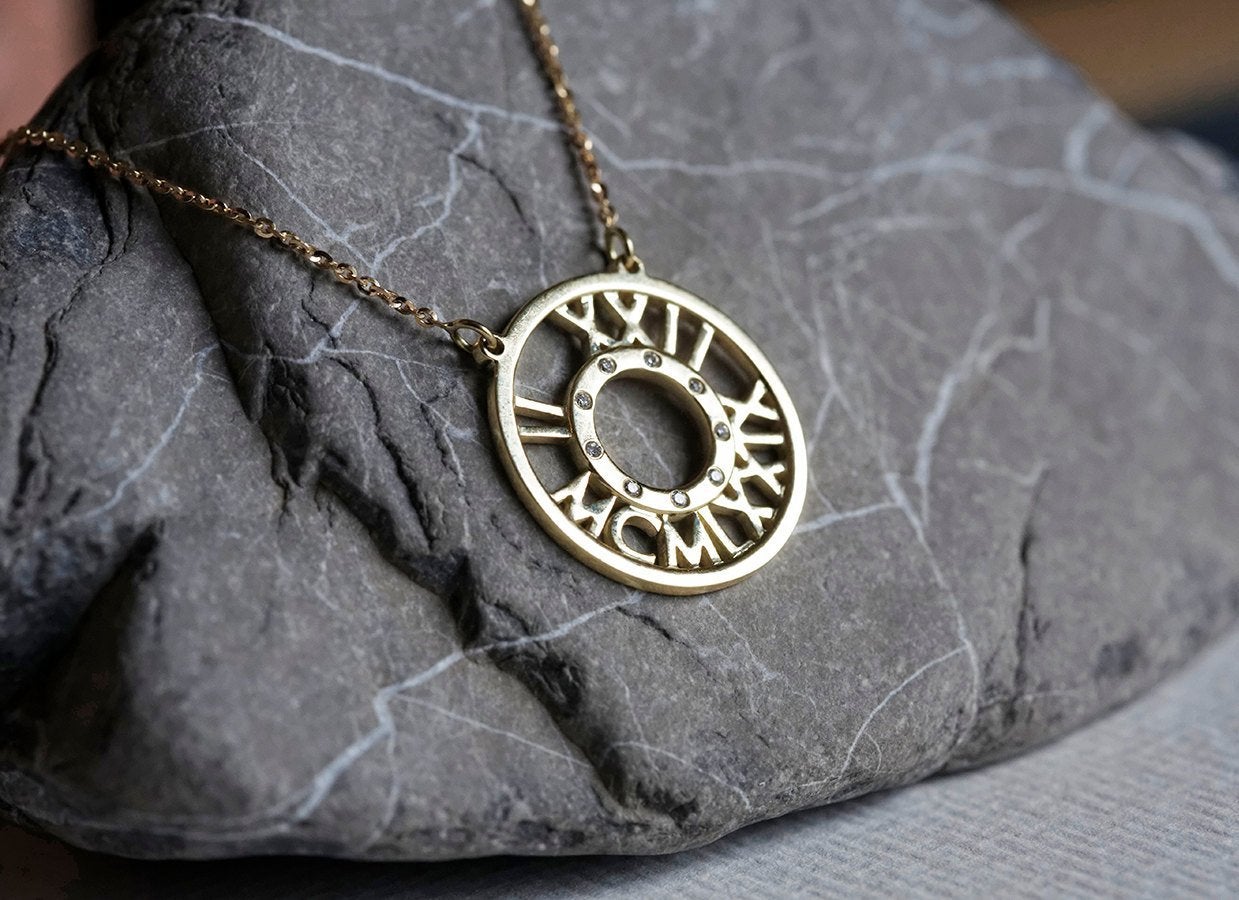 Gold necklace with roman numerals and white round diamonds