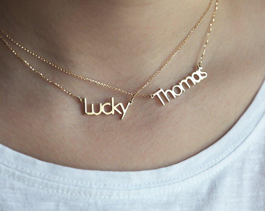 Two gold necklaces with personalized names