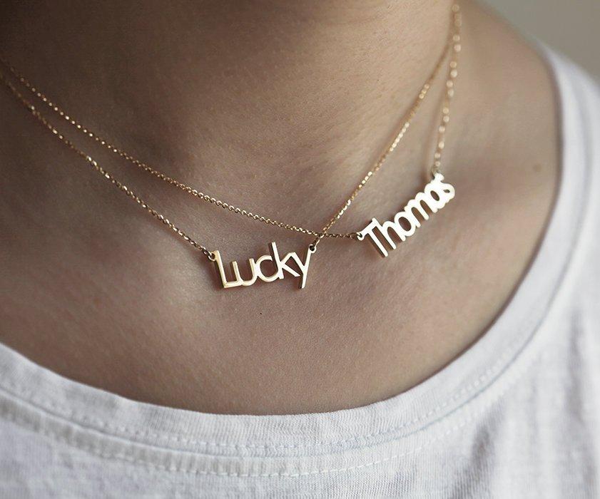 Two gold necklaces with personalized names