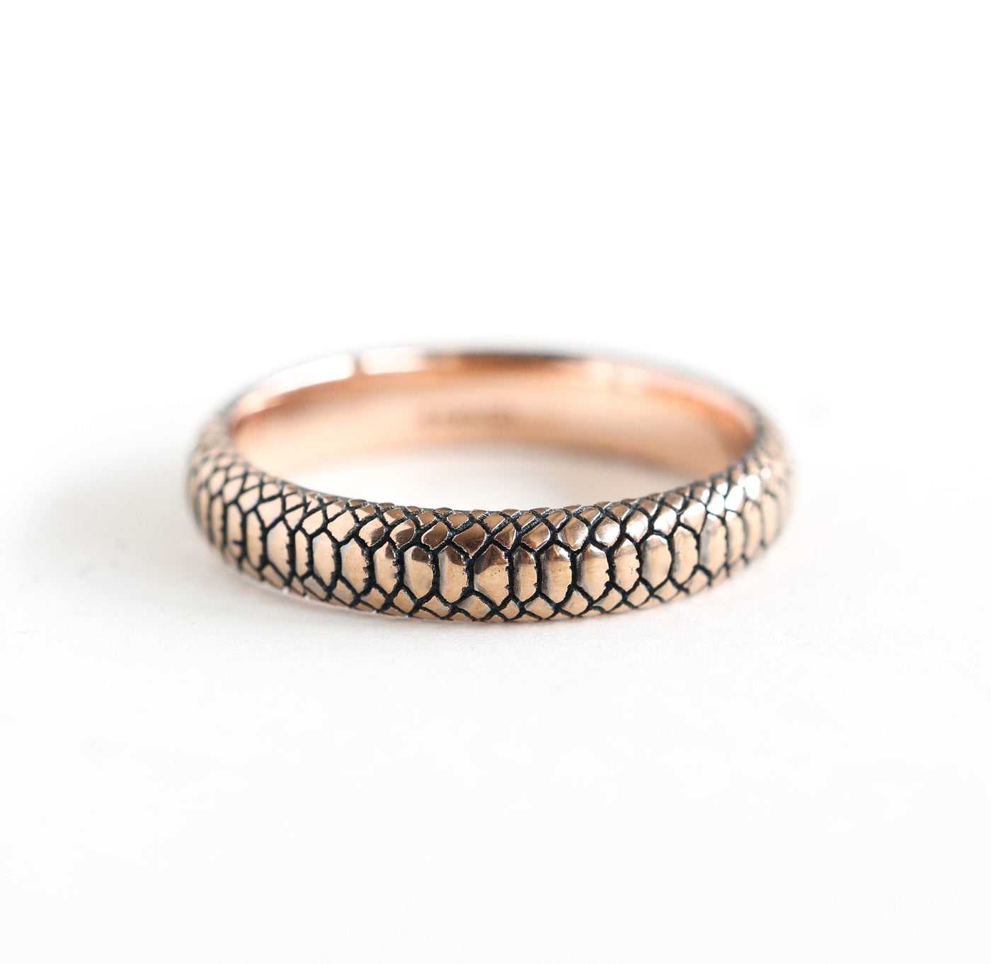 Gold snake band textured ring, showcasing intricate snake skin pattern in 14k gold.