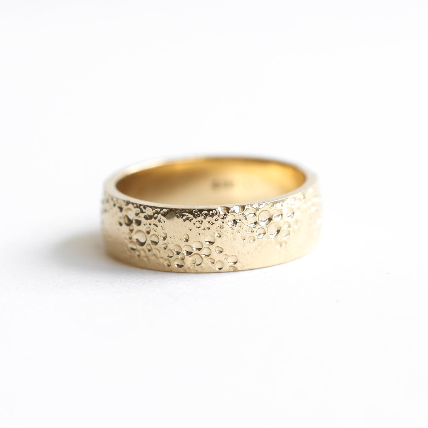 Textured gold wedding band, unisex design with twist, available in 14k/18k gold and platinum. Customize with gemstones.