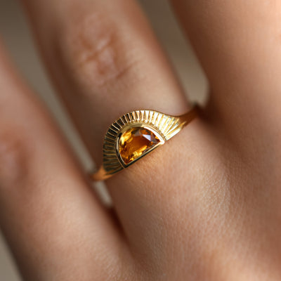 Half-moon-shaped golden orange sapphire ring