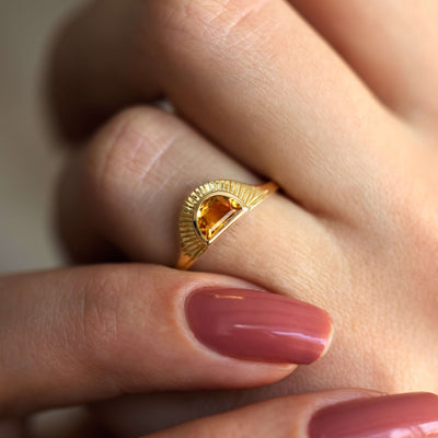 Half-moon-shaped golden orange sapphire ring