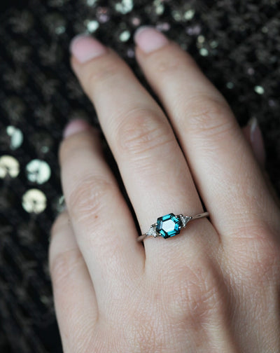 Hexagon-shaped teal sapphire ring with side diamonds