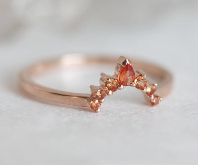 Round orange sapphire ring with diamond halo