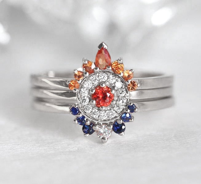 Round orange sapphire ring with diamond halo