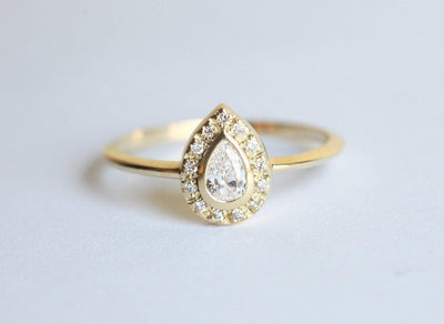 Pear-Cut White Diamond Halo Engagement Ring with Round White Diamonds surrounding the center diamond