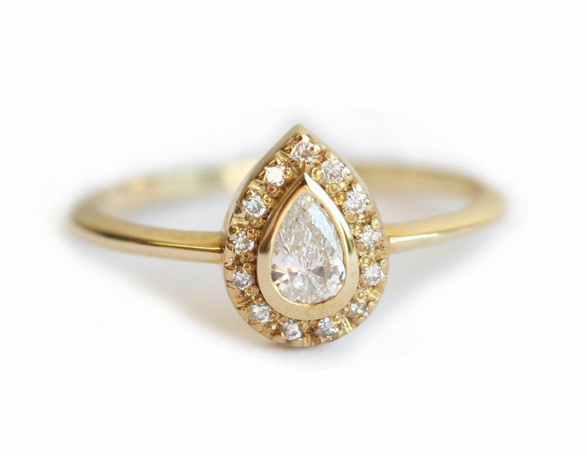 Pear-Cut White Diamond Halo Engagement Ring with Round White Diamonds surrounding the center diamond