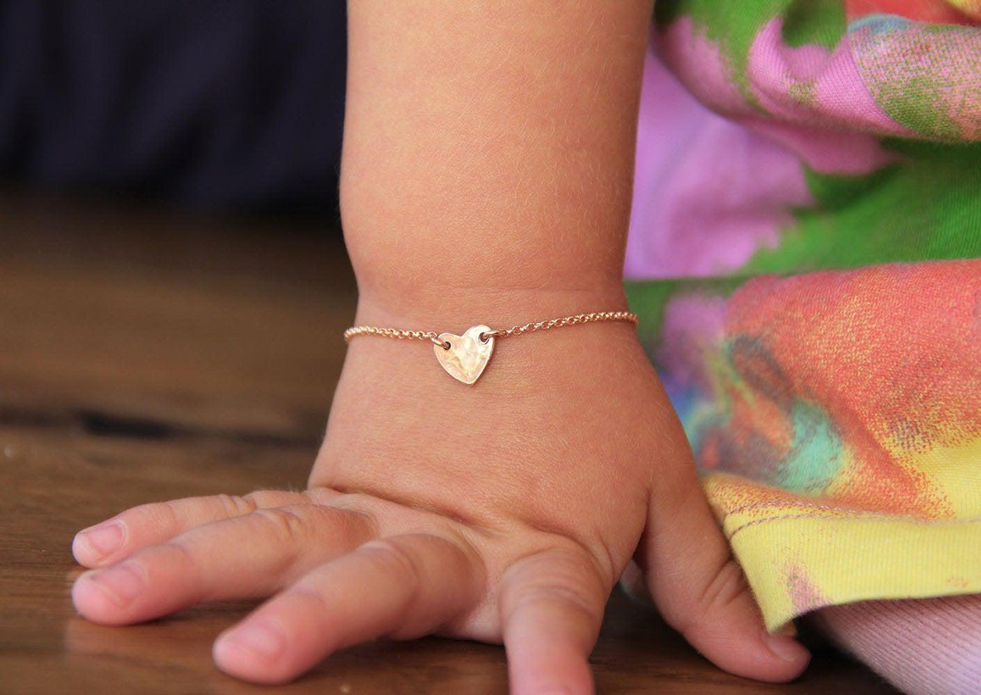 Infant's rose gold chain bracelet with heart charm and personalized initial letter