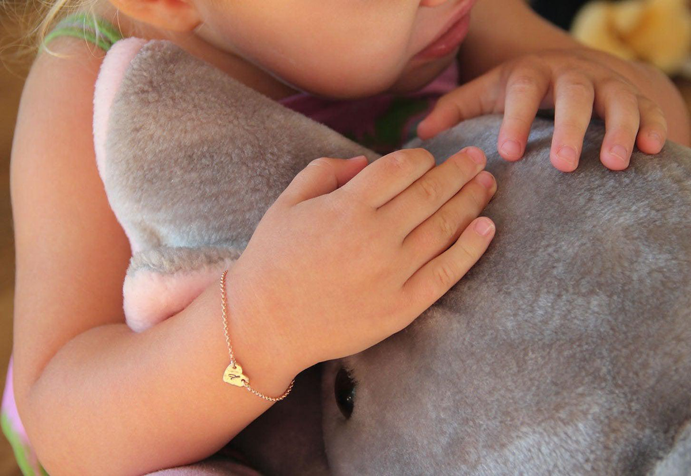 Infant's rose gold chain bracelet with heart charm and personalized initial letter