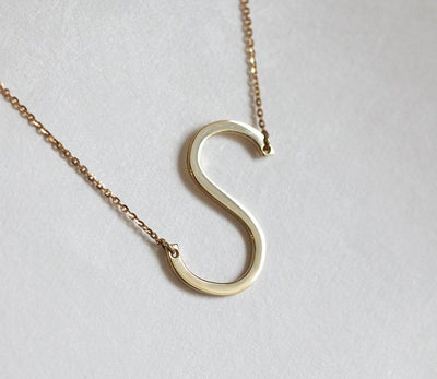 Gold necklace with large initial
