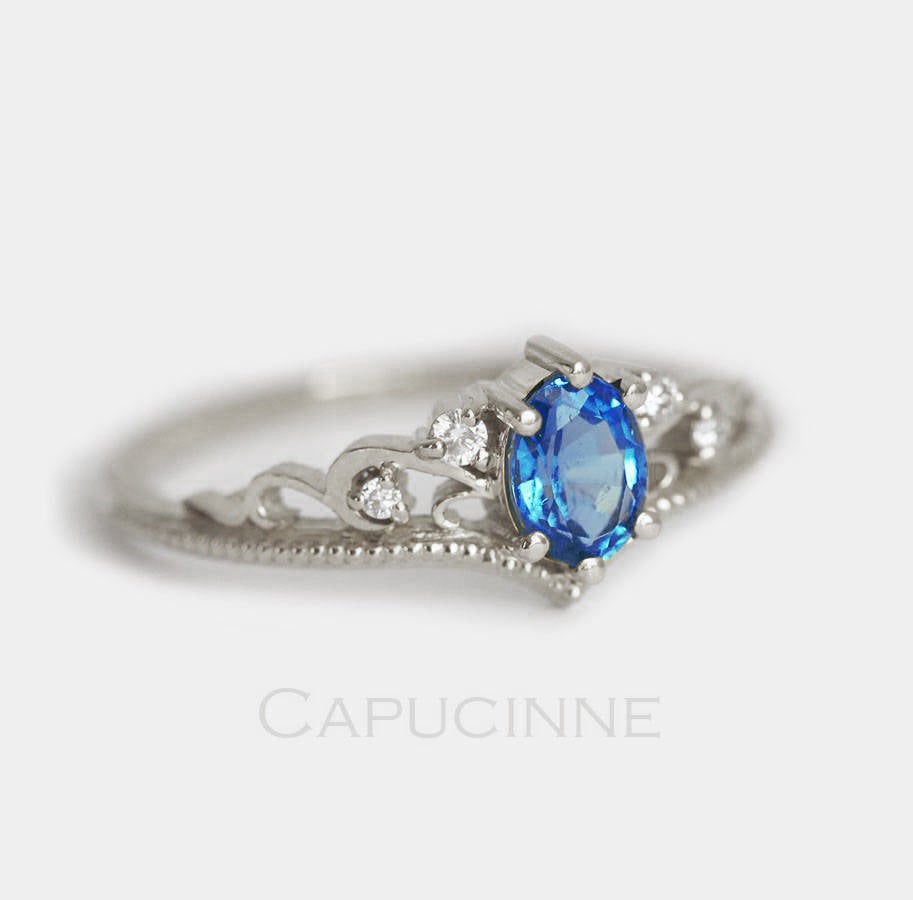 Blue vintage oval-shaped sapphire ring with side diamonds