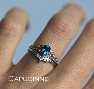 Blue vintage oval-shaped sapphire ring with side diamonds