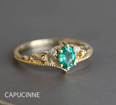 Green vintage oval-shaped sapphire ring with side diamonds