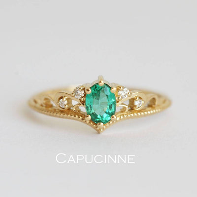 Green vintage oval-shaped sapphire ring with side diamonds